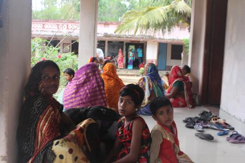 Families crouch outdoors in preparation of Cyclone Fani striking