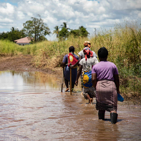 women walking through water