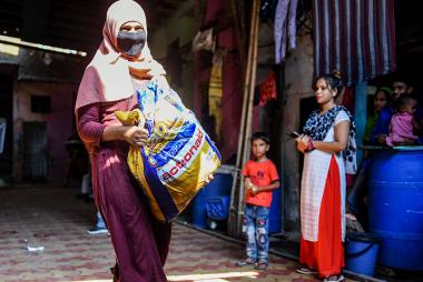 Members of ActionAid India’s Young Urban Women Programme in Dharavi hand out food as part of Covid relief distribution.