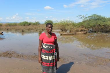 Esnert Thaison, 45, stands in front of her submerged crop - Tropical Storm Ana 