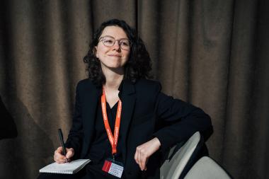 Iryna, Ukranian humanitarian worker poses in a chair.